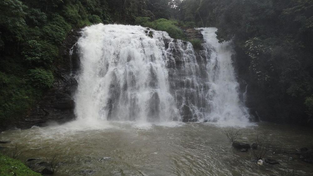 Abbey Falls cascading through forest in Coorg