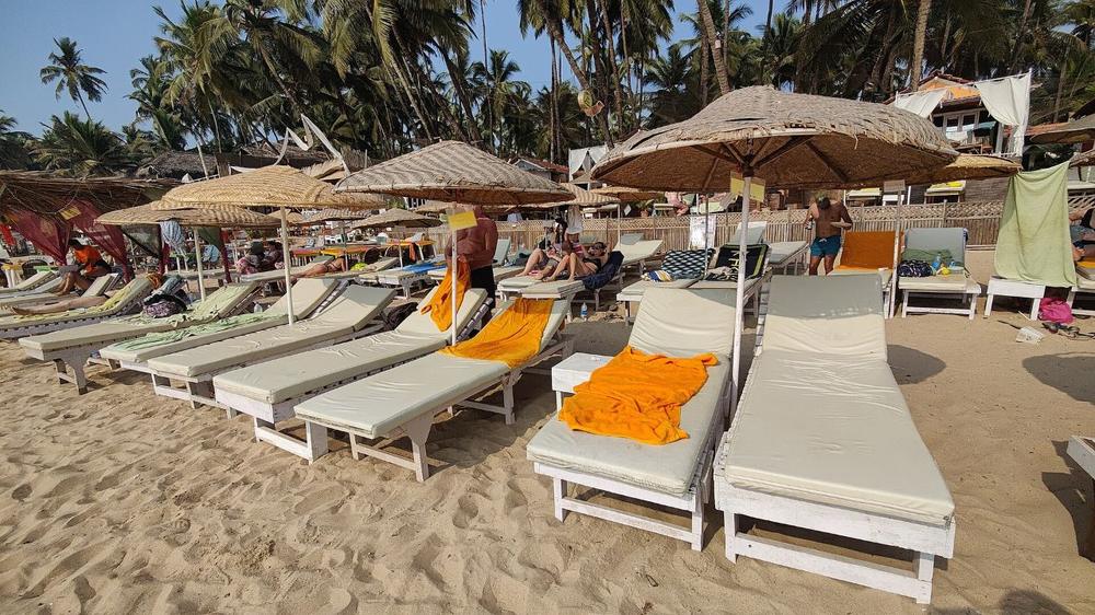 Sun loungers and umbrellas on Palolem beach, South Goa