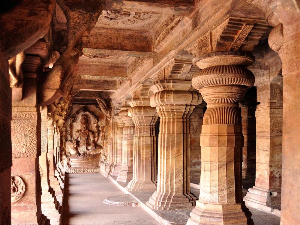 Carved pillars inside a rock-cut cave temple at Badami