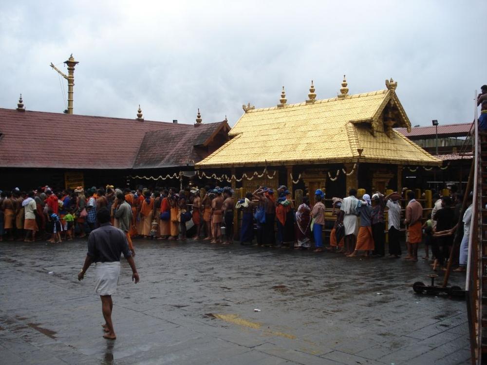 Devotees in the courtyard before the golden-roofed sanctum at Sabarimala